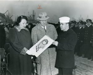 Parents of Robert Oesterwind receiveing a portrait of their son after he was killed onboard during the Korean War