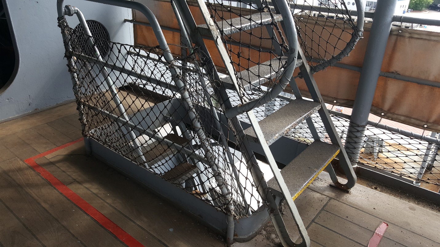 A steep ladder with hand rails along the tour route.